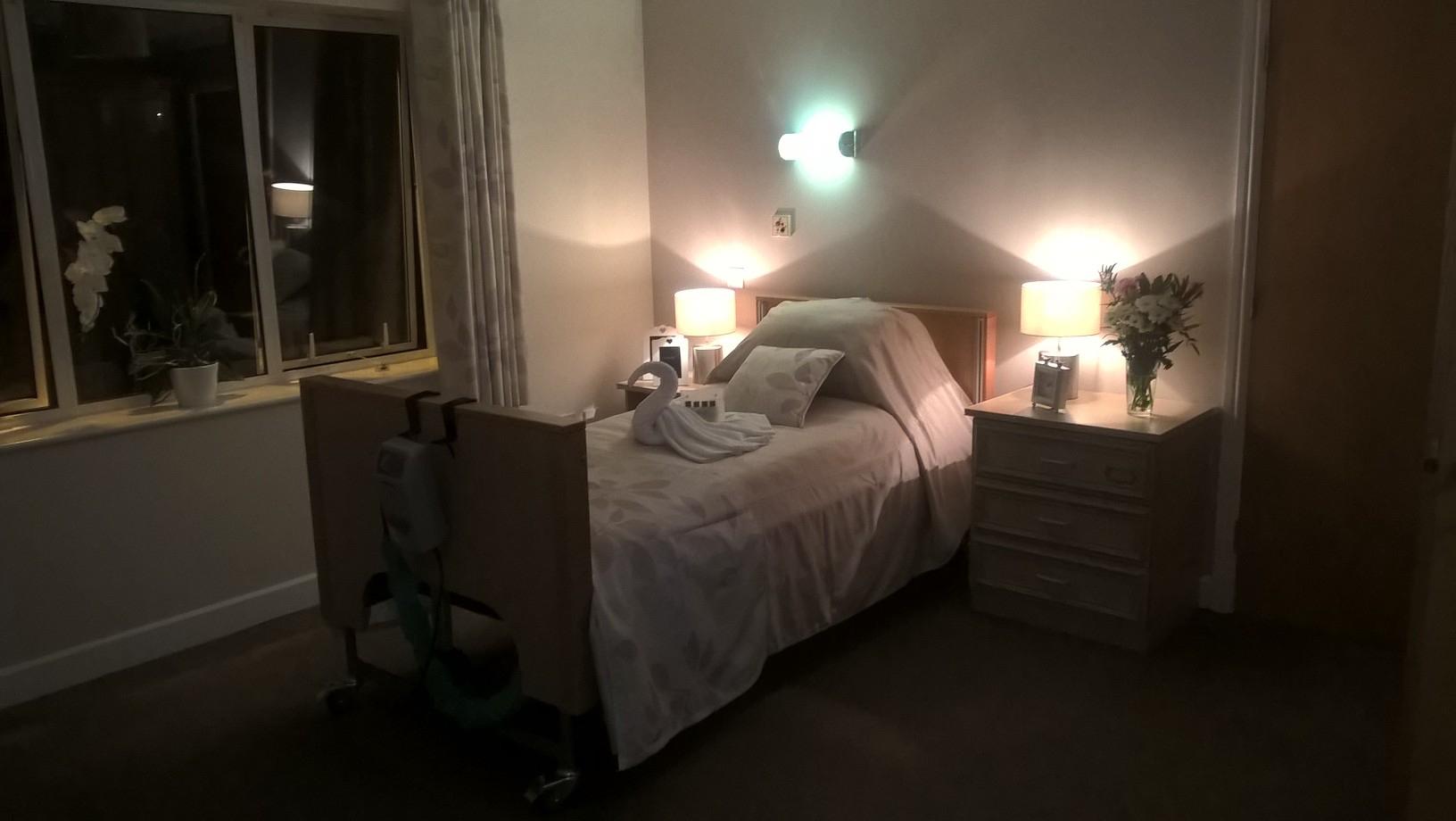 bedroom with made up bed at nighttime
